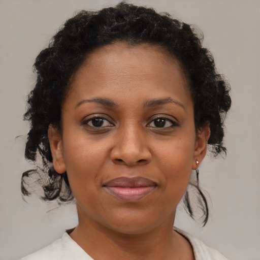 Joyful black young-adult female with medium  brown hair and brown eyes