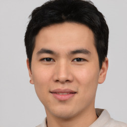 Joyful asian young-adult male with short  black hair and brown eyes