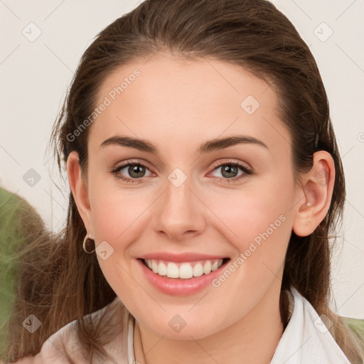 Joyful white young-adult female with long  brown hair and green eyes