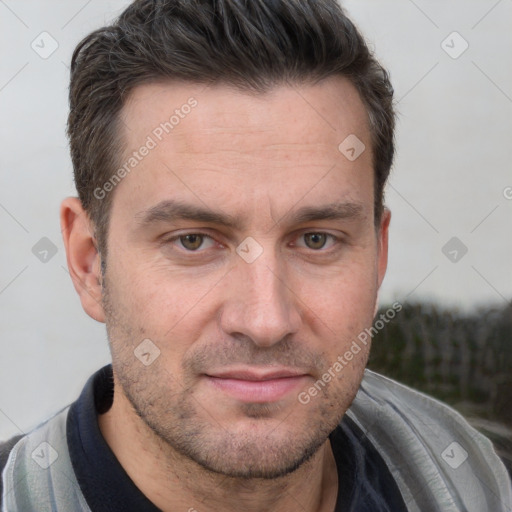 Joyful white adult male with short  brown hair and brown eyes