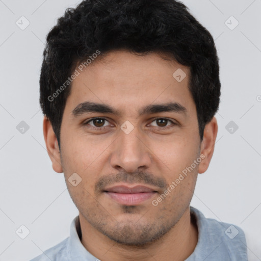 Joyful latino young-adult male with short  black hair and brown eyes