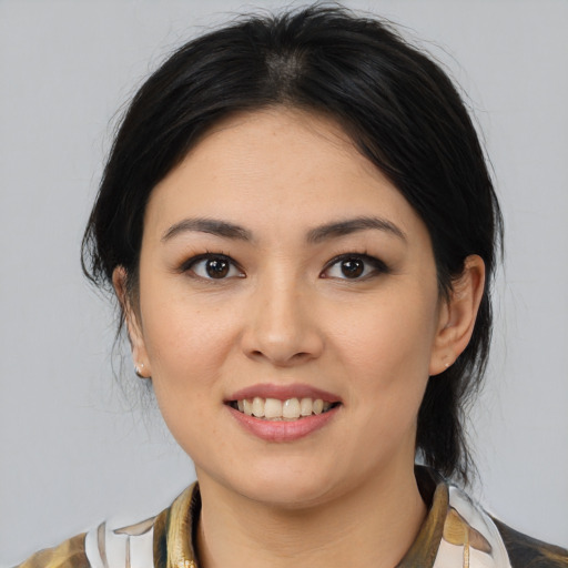 Joyful latino young-adult female with medium  brown hair and brown eyes