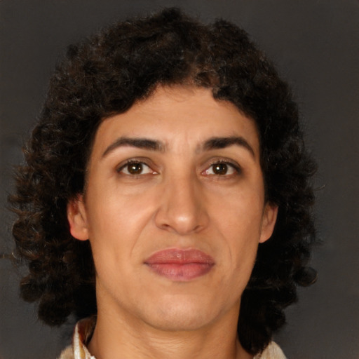 Joyful latino adult female with medium  brown hair and brown eyes