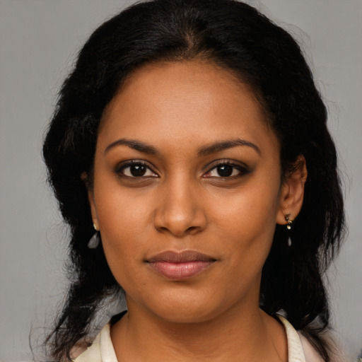 Joyful latino young-adult female with medium  black hair and brown eyes