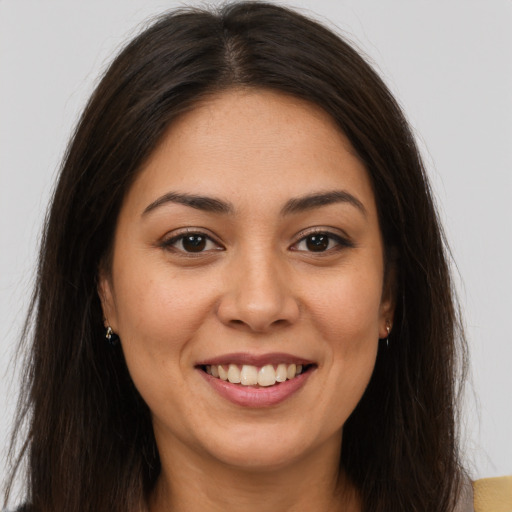 Joyful latino young-adult female with long  brown hair and brown eyes
