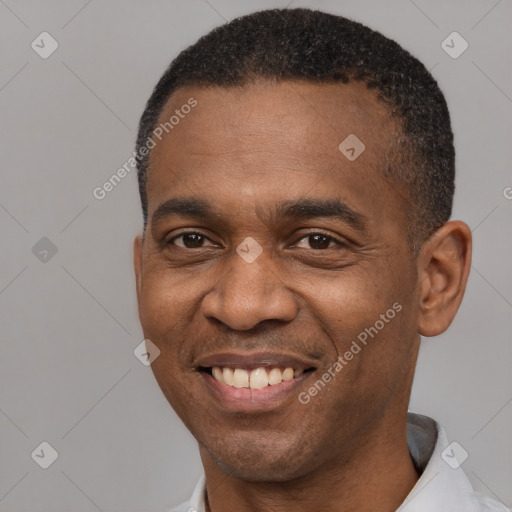 Joyful black adult male with short  black hair and brown eyes