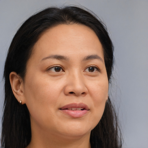 Joyful asian adult female with long  brown hair and brown eyes
