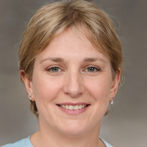 Joyful white adult female with medium  brown hair and grey eyes