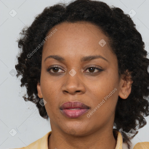 Joyful black adult female with medium  brown hair and brown eyes