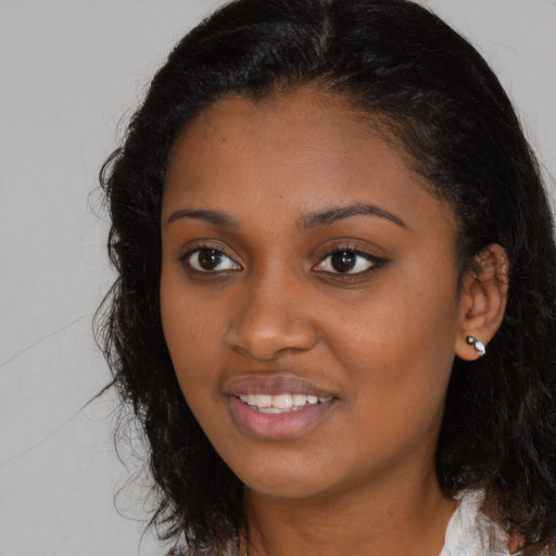 Joyful black young-adult female with medium  brown hair and brown eyes