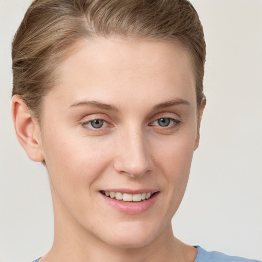 Joyful white young-adult female with short  brown hair and grey eyes