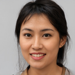 Joyful asian young-adult female with medium  brown hair and brown eyes