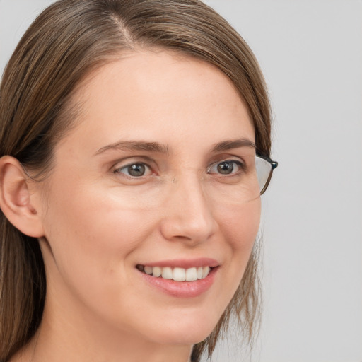 Joyful white young-adult female with long  brown hair and grey eyes