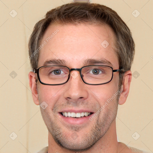 Joyful white adult male with short  brown hair and grey eyes