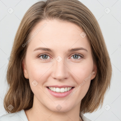 Joyful white young-adult female with medium  brown hair and green eyes