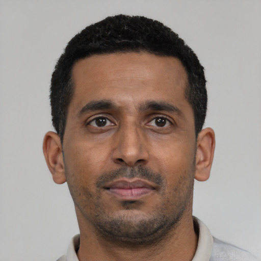 Neutral black young-adult male with short  black hair and brown eyes