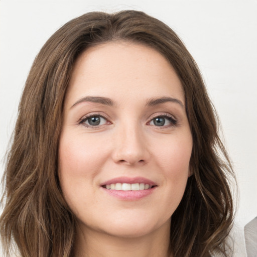 Joyful white young-adult female with long  brown hair and green eyes