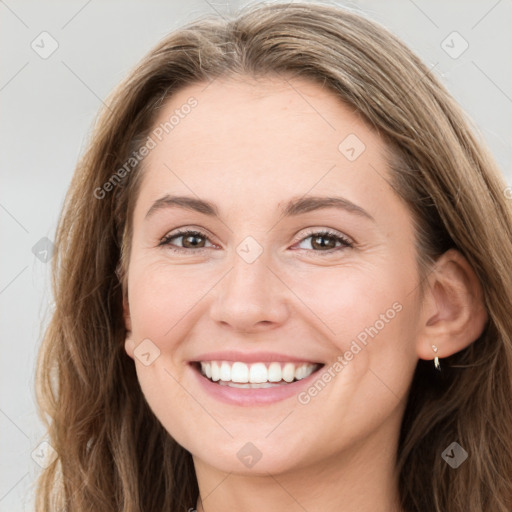 Joyful white young-adult female with long  brown hair and green eyes