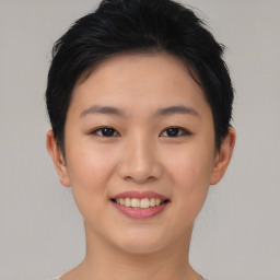 Joyful asian young-adult female with short  brown hair and brown eyes