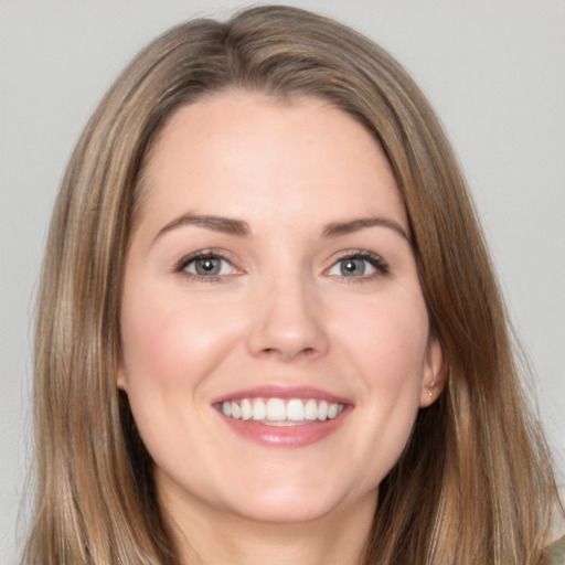 Joyful white young-adult female with long  brown hair and brown eyes