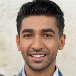 Joyful white young-adult male with short  black hair and brown eyes