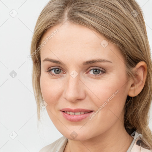 Joyful white young-adult female with medium  brown hair and grey eyes