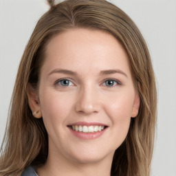 Joyful white young-adult female with long  brown hair and grey eyes