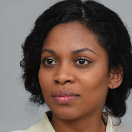 Joyful black young-adult female with medium  black hair and brown eyes