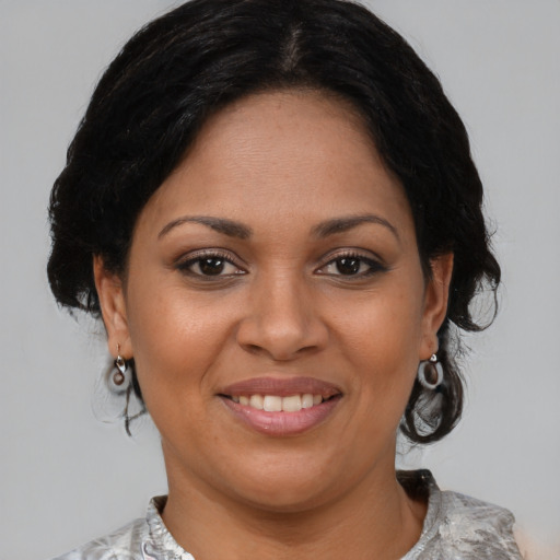 Joyful latino adult female with medium  brown hair and brown eyes