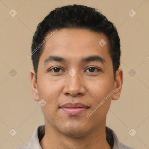 Joyful latino young-adult male with short  black hair and brown eyes