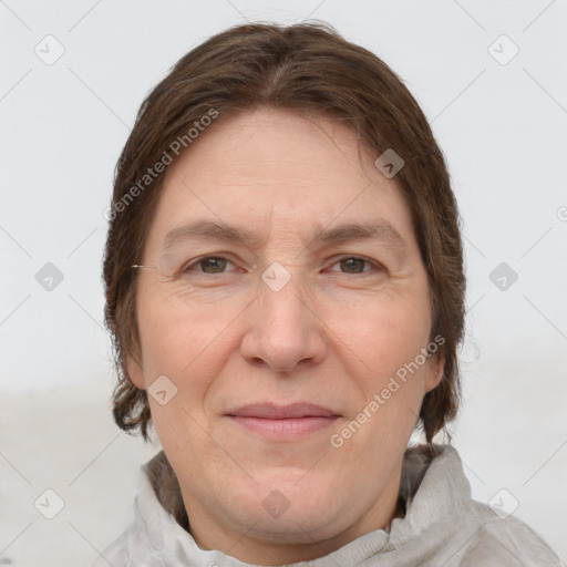 Joyful white adult female with short  brown hair and grey eyes