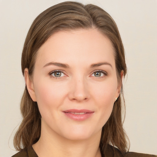 Joyful white young-adult female with medium  brown hair and grey eyes