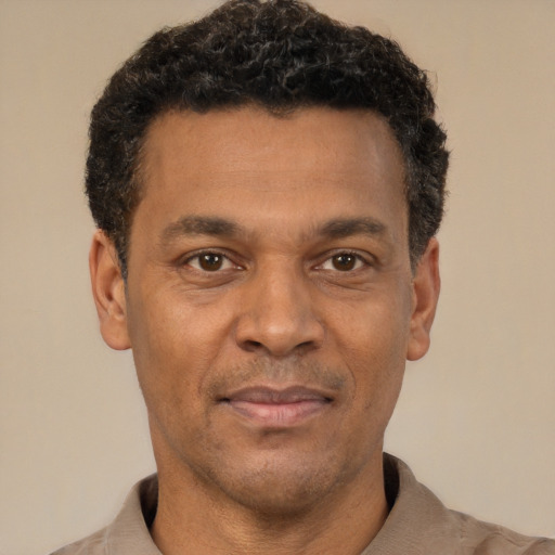 Joyful latino adult male with short  brown hair and brown eyes