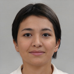 Joyful asian young-adult female with medium  brown hair and brown eyes