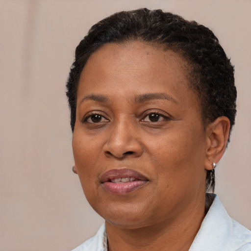 Joyful black adult female with short  black hair and brown eyes