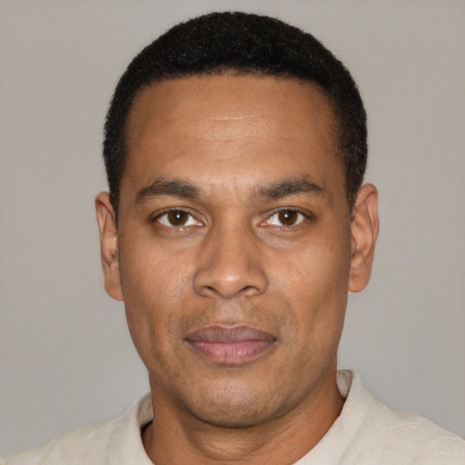 Joyful black adult male with short  black hair and brown eyes