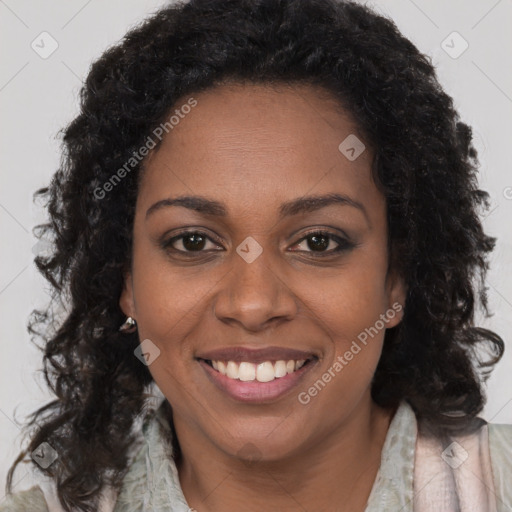 Joyful black young-adult female with long  brown hair and brown eyes