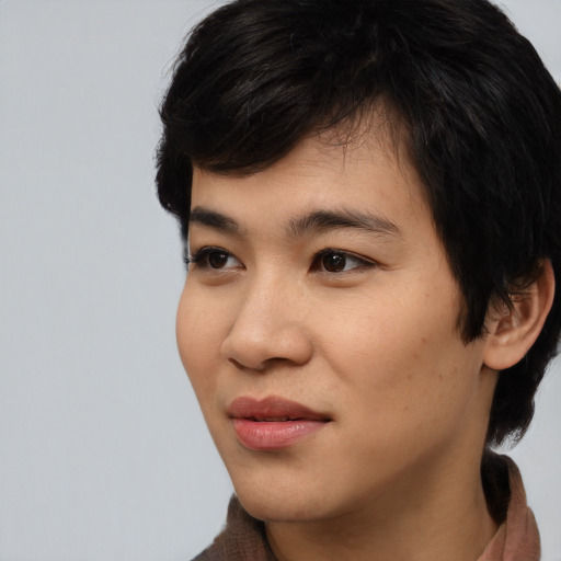 Joyful asian young-adult male with medium  black hair and brown eyes