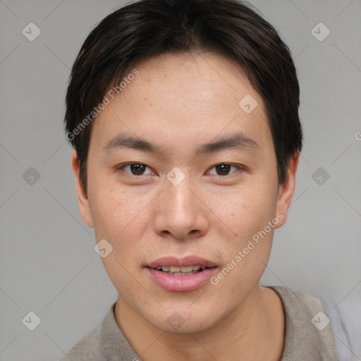 Joyful asian young-adult male with short  brown hair and brown eyes