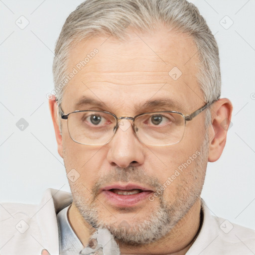 Neutral white middle-aged male with short  gray hair and brown eyes