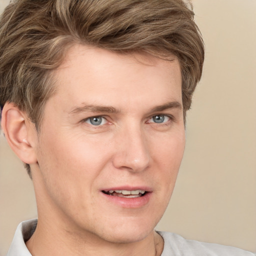 Joyful white young-adult male with short  brown hair and grey eyes