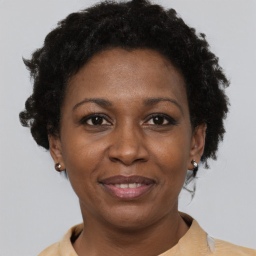 Joyful black adult female with short  brown hair and brown eyes