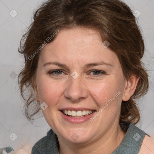 Joyful white adult female with medium  brown hair and blue eyes