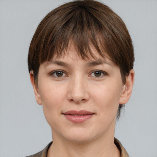 Joyful white young-adult female with medium  brown hair and grey eyes