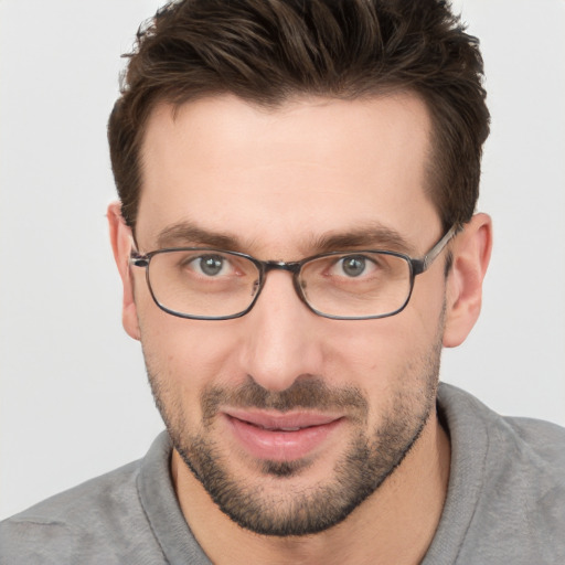 Joyful white young-adult male with short  brown hair and grey eyes