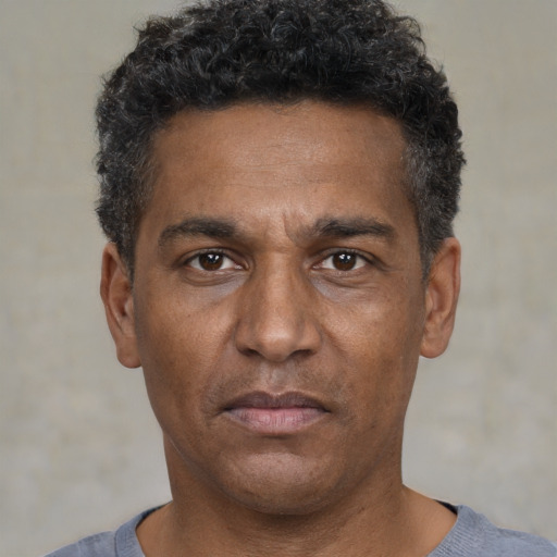 Neutral black adult male with short  black hair and brown eyes