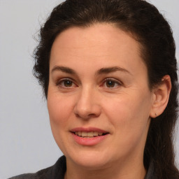 Joyful white adult female with medium  brown hair and brown eyes