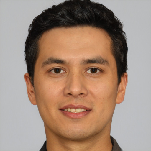 Joyful white young-adult male with short  black hair and brown eyes