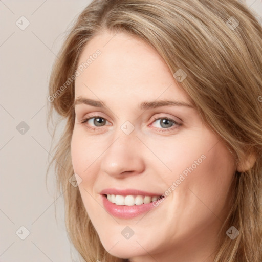 Joyful white young-adult female with long  brown hair and blue eyes