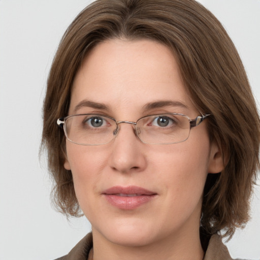 Joyful white adult female with medium  brown hair and grey eyes